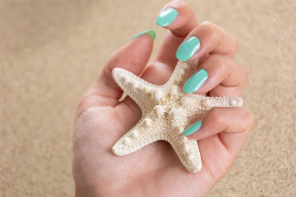 Young Beautiful Girl Hand Turquoise Color Nails Polish Holding Starfish — Stock Photo, Image