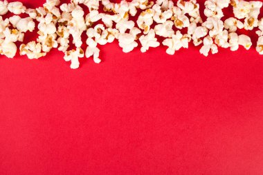 Kırmızı zemin üzerinde patlamış mısır, boş alan, üst görünüm