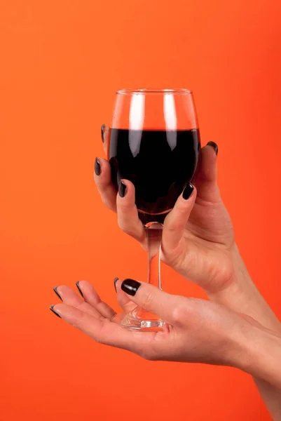 Female Holding Wine Glass Hands Black Nails Isolated Orange Background — Stock Photo, Image