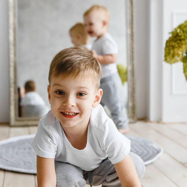 Küçük Çocuk Ahşap Zeminde Örgü Örüp Gülümsüyor Kısımda Örgü Tarzı — Stok fotoğraf