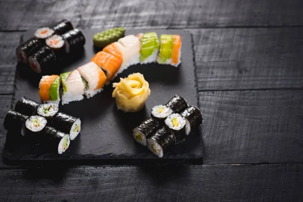 Bir dizi farklı suşi havyar ile siyah arka plan üzerine alır.
