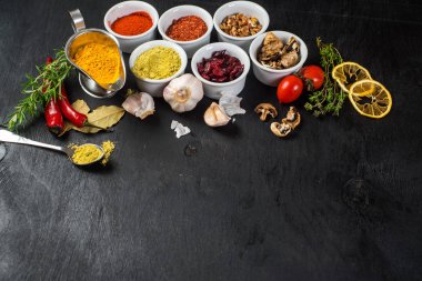 Siyah arka plan üzerine ham ve kuru sebzeli farklı baharatlar. Üstten görünüm. boş alan