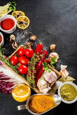 Siyah arka plan üzerine ham ve kuru sebzeli farklı baharatlar. Üstten görünüm. boş alan