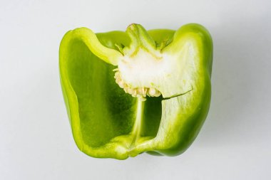 Beyaz arka planda olgun yeşil biber kesiği