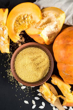 Siyah ahşap arka planda çiğ balkabağı ve mercimek tohumu. Üst Manzara. Boşluğu kopyala