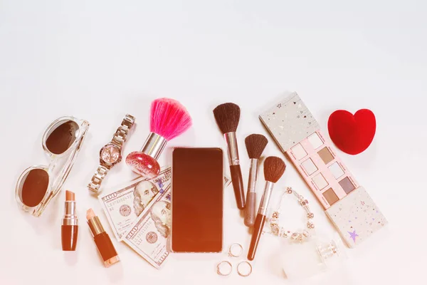 Womans accessories and cosmetics flatlay on white background. Top view. Copy space