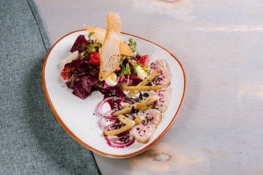 Sebzeli et yemeği, kızarmış ekmek ve ahşap arka planda sos.