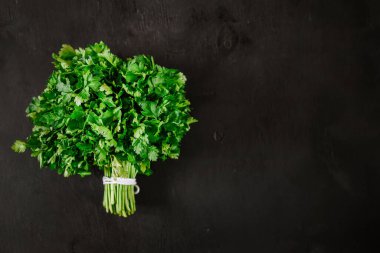 Siyah arka planda bir demet taze maydanoz. Üst Manzara. Uzayı kopyala Düz Yatay