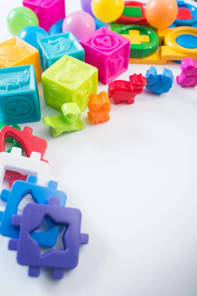 Different colored children toys, cubes on white background