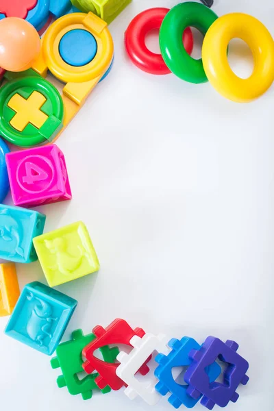 Different colored children toys, cubes on white background