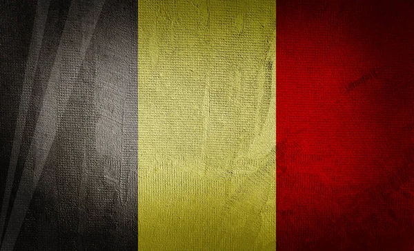 暗い質感の背景にベルギーの旗 — ストック写真