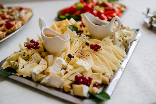 Plate with different cheese on the buffet table