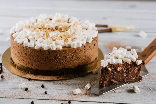 Big chocolate cake with marshmallows on white background