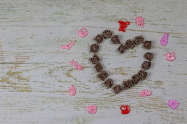 Kalp karanlık GÜL oyuncaklar ile yapılmış. Ahşap arka plan üzerinde Yukarıdaki fotoğraf. Aşk, Sevgililer Günü Bayramı. Kartpostal kopya alanı ile.