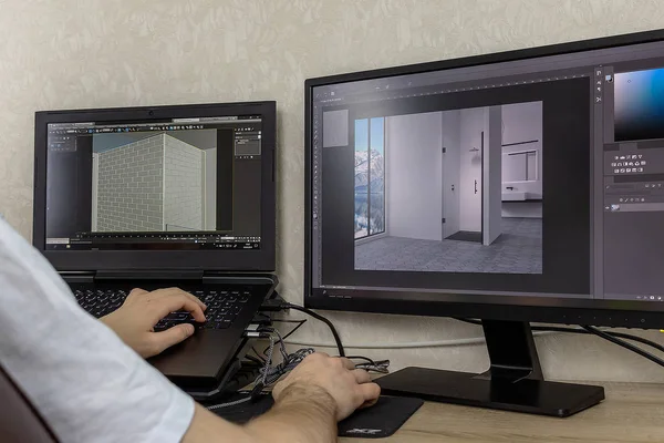 3D modelleme bilgisayardaki. Adam iki monitörde grafik tasarım geliştirir.