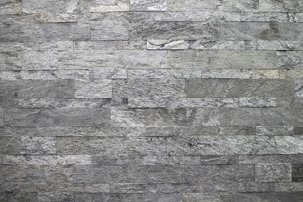 Piedra natural, mampostería lineal lisa, textura en relieve gris. La pared está hecha de piedra, la superficie está texturizada, gris . — Foto de Stock