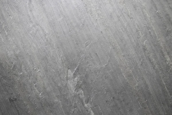 Doğal taş, gri kabartma doku. Duvar betondan yapılmış, yüzeydokulu, gri.