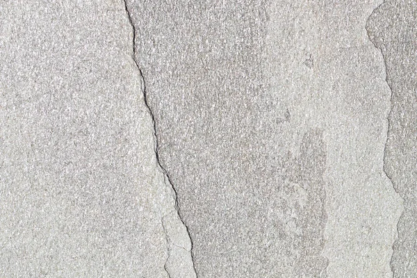 Textura de pedra natural com uma rachadura. O fundo é uma pedra natural de cor amarela com uma divisão. Textura com destruição e rachadura . — Fotografia de Stock