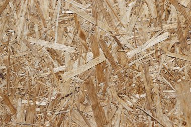 Sarı preslenmiş ahşap talış doku. Yonga levha closeup, arka plan boş. Basın yakın çekim altında Kurulu talaş.