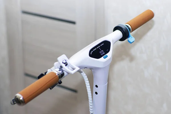Elektrikli scooter kontrol paneli ile beyaz. Kahverengi deri kolları ile Scooter direksiyon simidi. Mavi kol hızlandırıcı.