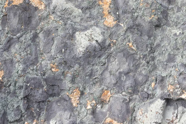 Gold ore texture. Gray stone background. The surface of the marb