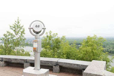 Şehrin yakın çekim keşfetmek için ödenen dürbün. Şehri keşfetmek için gözetleme güvertesi. Şehir manzaralı gümüş renkli teleskop.