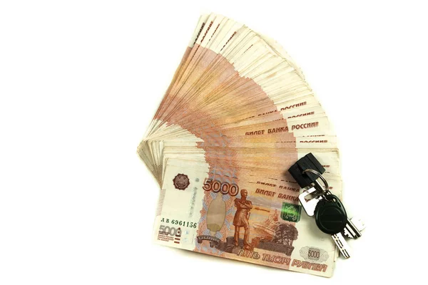 Gayrimenkul satın almak için beş bininci Rus rublesi tasarrufu. Anahtarlarla birlikte para paketi. Beyaz arka planda izole dolar banknotları.
