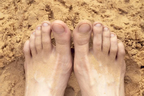 Feet resting on the beach woman. Toned.