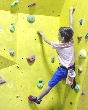 Ücretsiz dağcı çocuk genç çocuk içinde jimnastik salonu, yapay kayalar üzerinde pratik bouldering