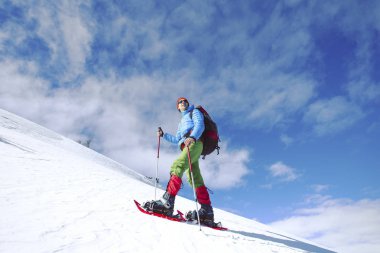 Kış kar ayakkabıları ile dağlarda hiking.