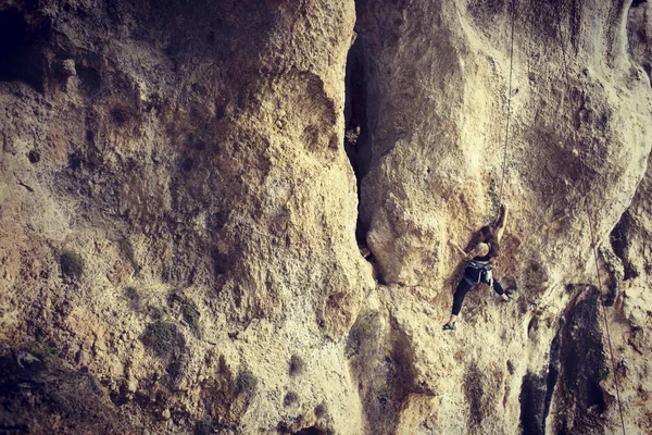 Bergbeklimmer meisje klimt moeilijke route op de kliffen — Stockfoto