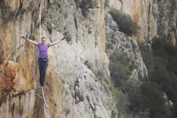 Womanbalancing on the rope concept of risk taking and challenge. — Stock Photo, Image