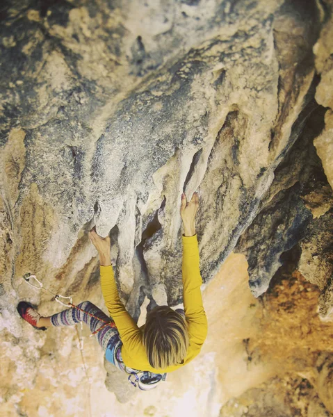 The girl climbs the rock. Fitness in nature and rock climbing. T