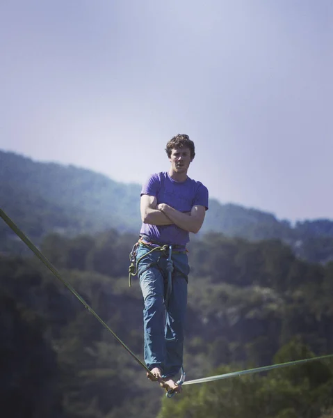 Un homme marche le long d'une fronde tendue. Highline dans la montagne — Photo