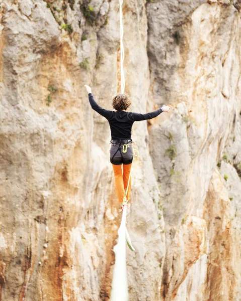 Ein Mann Läuft Einer Gestreckten Schlinge Entlang Highline Den Bergen lizenzfreie Stockbilder