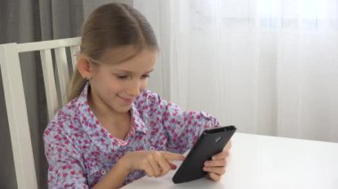 Çocuk Tablet oynarken, kız portre sörf Smartphone, çocuk yüz ofisinde 4k