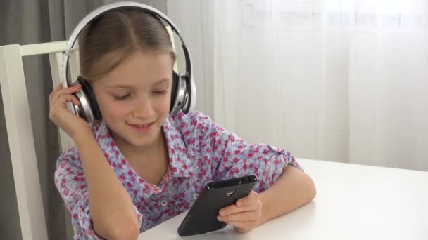 Child Listening Music Headphones School Girl Using Smartphone Kitchen — Stock Video