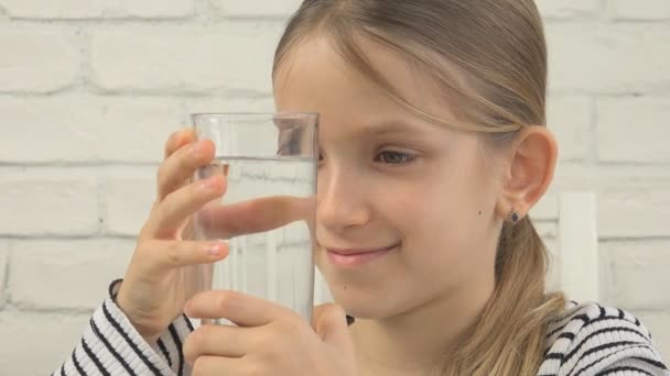 Gyerek konyha, szomjas lány tanul pohár friss vizet ivóvíz — Stock videók