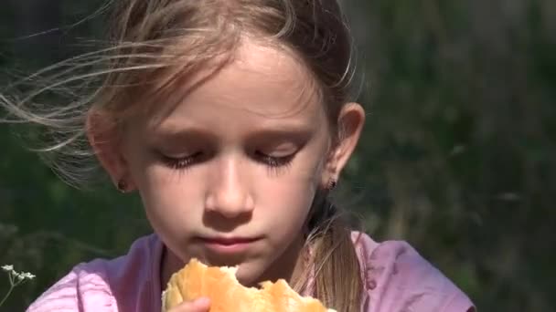 Грустный ребенок в заброшенном доме Депрессивная заблудшая девушка, бездомный ребенок ест хлеб — стоковое видео