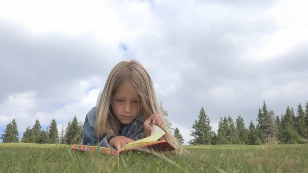 Child Reading Book in Park, Kid Student Studying in Nature, Girl Relax Outdoor