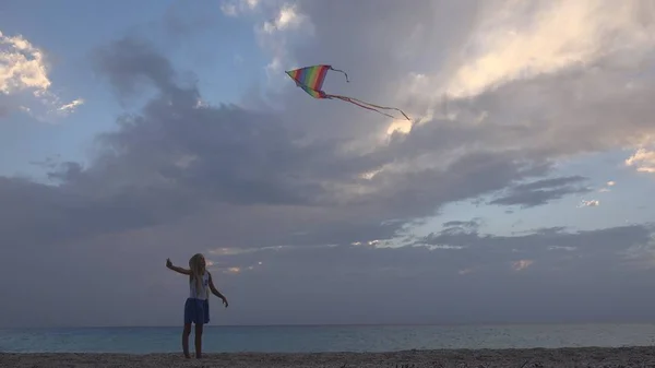 Child Playing Flying Kite on Beach at Sunset, Happy Little Girl on Coastline