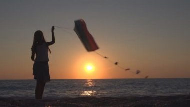 Uçan uçurtma Beach, çocuk gün batımında, sahil şeridi üzerinde mutlu kız oynayan çocuk