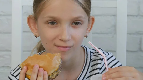 Child Eating Hamburger in Restaurant, Kid and Fast Food, Girl Drinking Juice