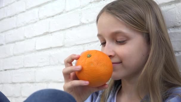 Gyermek Narancsot eszik Gyümölcs Reggelinél, Lány Kölyök Szaglás Egészséges Élelmiszer Konyha — Stock videók