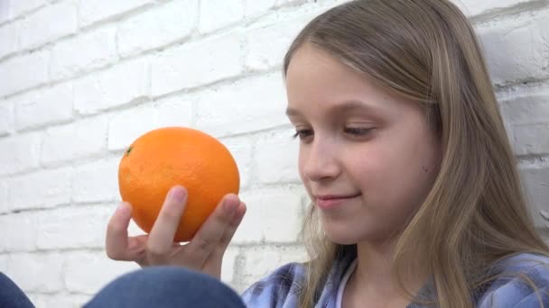 Child Eating Oranges Fruits at Breakfast, Girl Kid Smelling Healthy Food Kitchen