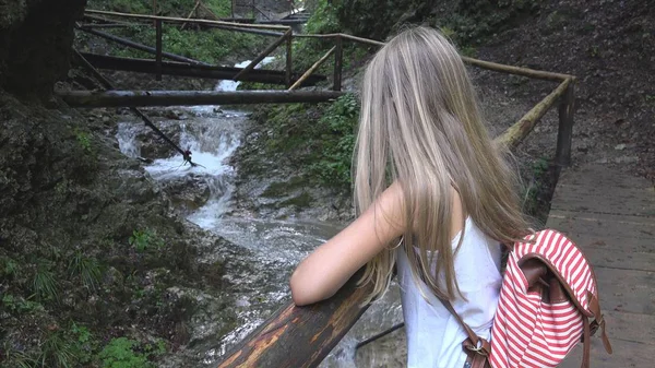 Kind op brug in Bergen, Kid wandelen in de natuur, meisje op zoek een rivier, stroom — Stockfoto