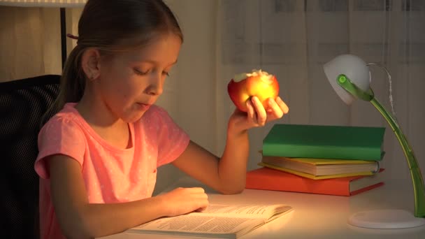 Kid Reading Barnätande Apple Medan Studerar För Skolan Läxor Flicka — Stockvideo