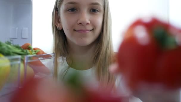 Kid Eating Tomato from Fridge, Hungry Child Eats Fresh Vegetables in Refrigerator, Young Girl at Diet, Healthy Food in Kitchen — стокове відео