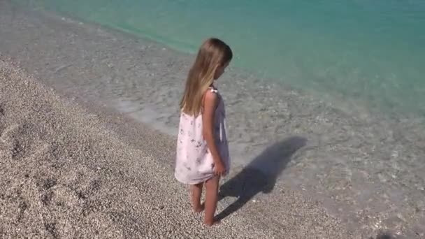 Niño jugando en la playa, Niño mirando las olas del mar, Niña viendo el paisaje marino en las vacaciones de verano — Vídeo de stock