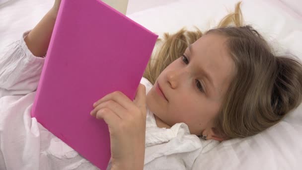 Kid Learning Reading a Book, Child Relaxing in Bed at Home, Blonde Girl Face Studying in Bedroom, Children Education — Stock Video